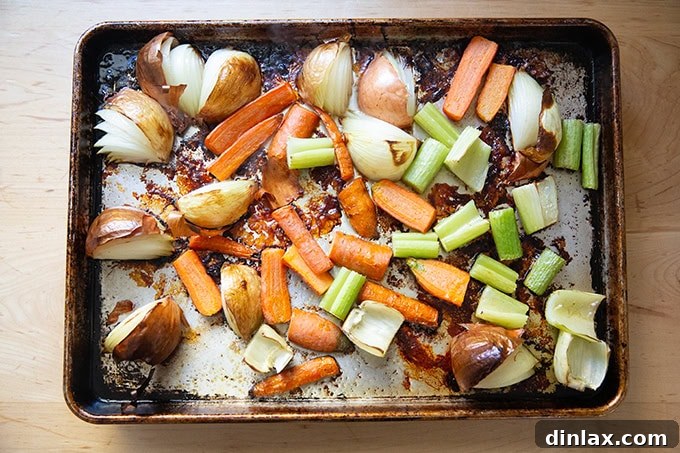 Make Ahead Roasted Turkey Wing Stock 9 Roasted vegetables, including carrots, onions, and celery, on a sheet pan, now golden and tender after their time in the oven.