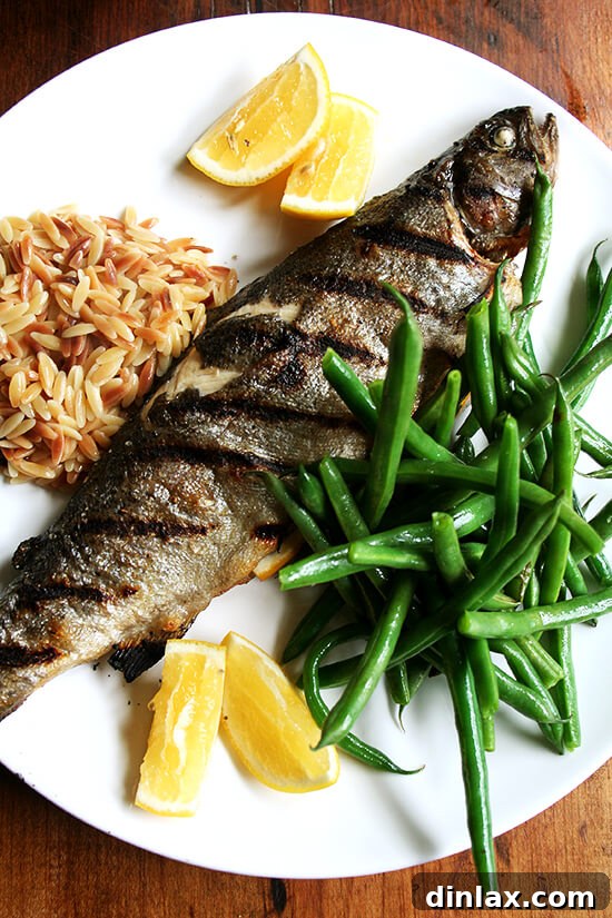 Whole grilled trout with green beans and orzo Whole grilled trout served with steamed green beans and brown butter orzo