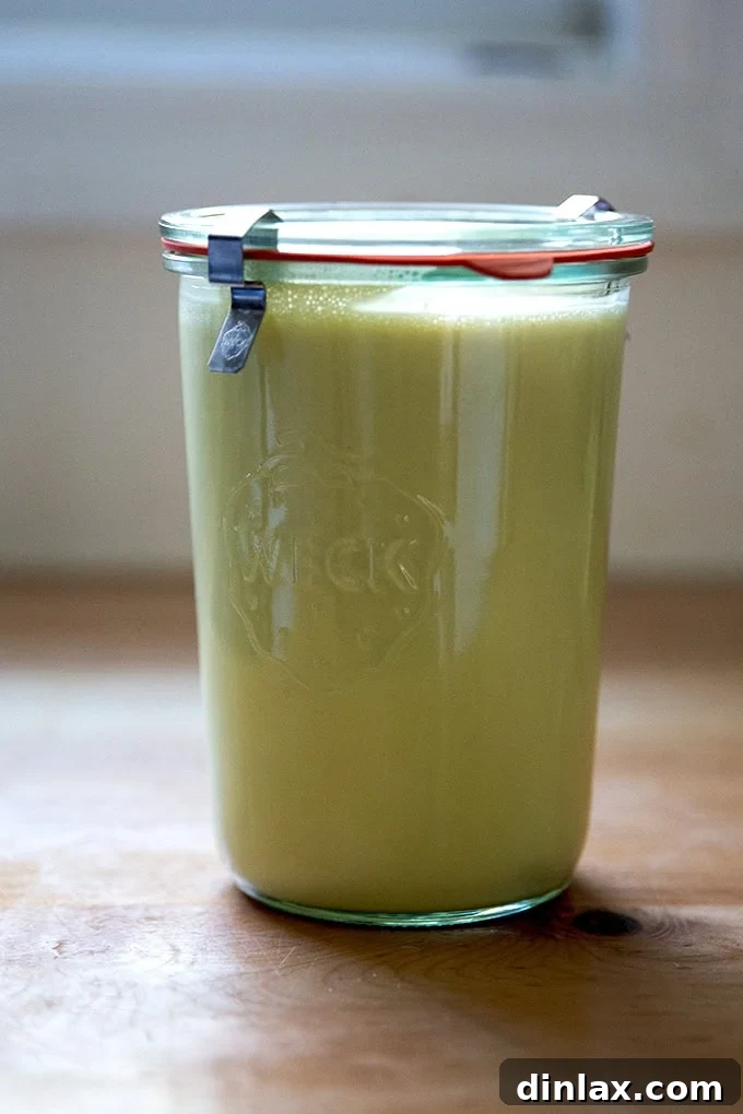 Perfect Caesar Dressing Your Way 11 A larger, wide-mouth Weck Jar filled with a generous amount of homemade Caesar dressing, emphasizing the 'large batch' concept.