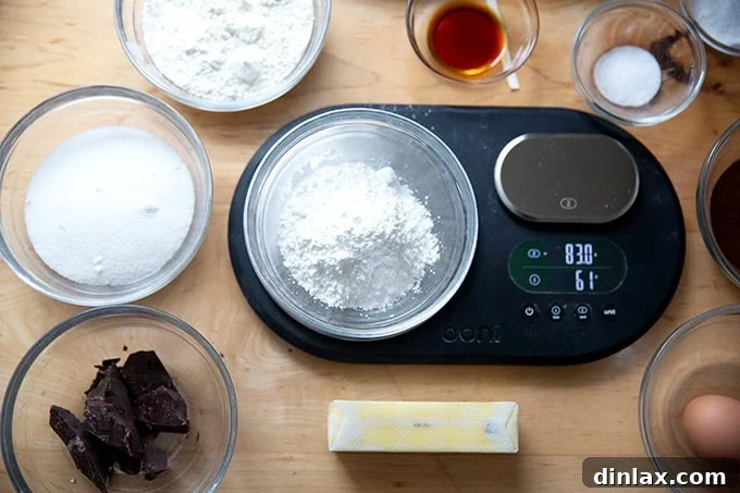 A digital kitchen scale weighing ingredients for chocolate crinkle cookies, emphasizing accuracy.