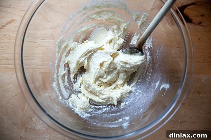 A bowl of creamed butter and sugar, showing the light and fluffy texture achieved after beating.