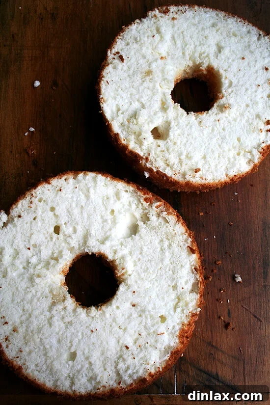A freshly halved angel food cake, revealing its fluffy interior