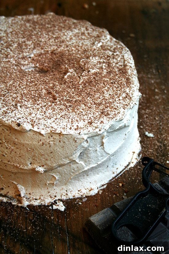 Frosted angel food cake topped with elegant chocolate shavings