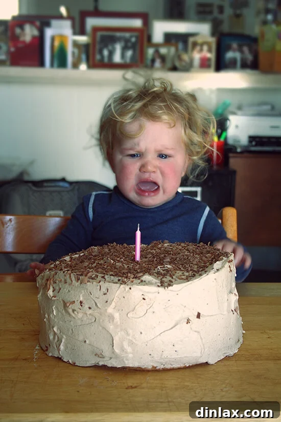 Ella smiling with her first birthday angel food cake