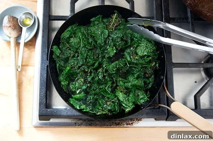 Effortless Baked Pasta: Make It, Share It, Freeze It 11 Fresh kale leaves sautéing in a hot skillet on the stovetop, wilting down.