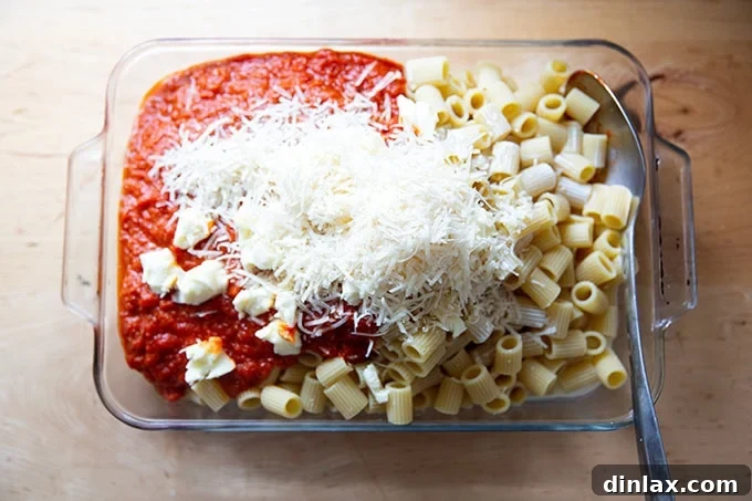 Effortless Baked Pasta: Make It, Share It, Freeze It 13 A 9x13-inch pan filled with all the ingredients for baked pasta, ready for mixing.