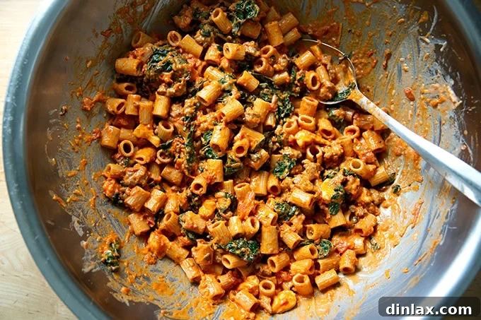 Effortless Baked Pasta: Make It, Share It, Freeze It 14 All baked pasta ingredients beautifully tossed together in a large mixing bowl, ready to be transferred to a baking dish.