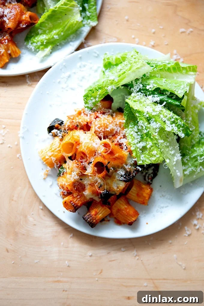 Effortless Baked Pasta: Make It, Share It, Freeze It 18 A plate featuring a generous portion of baked pasta alongside a fresh green salad.
