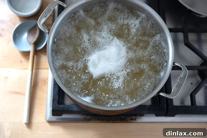 Effortless Baked Pasta: Make It, Share It, Freeze It 6 A pot of penne pasta vigorously boiling on a stovetop burner.