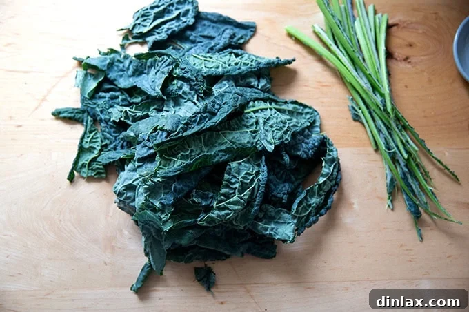 Effortless Baked Pasta: Make It, Share It, Freeze It 9 Neatly stemmed Tuscan kale leaves arranged on a clean countertop.