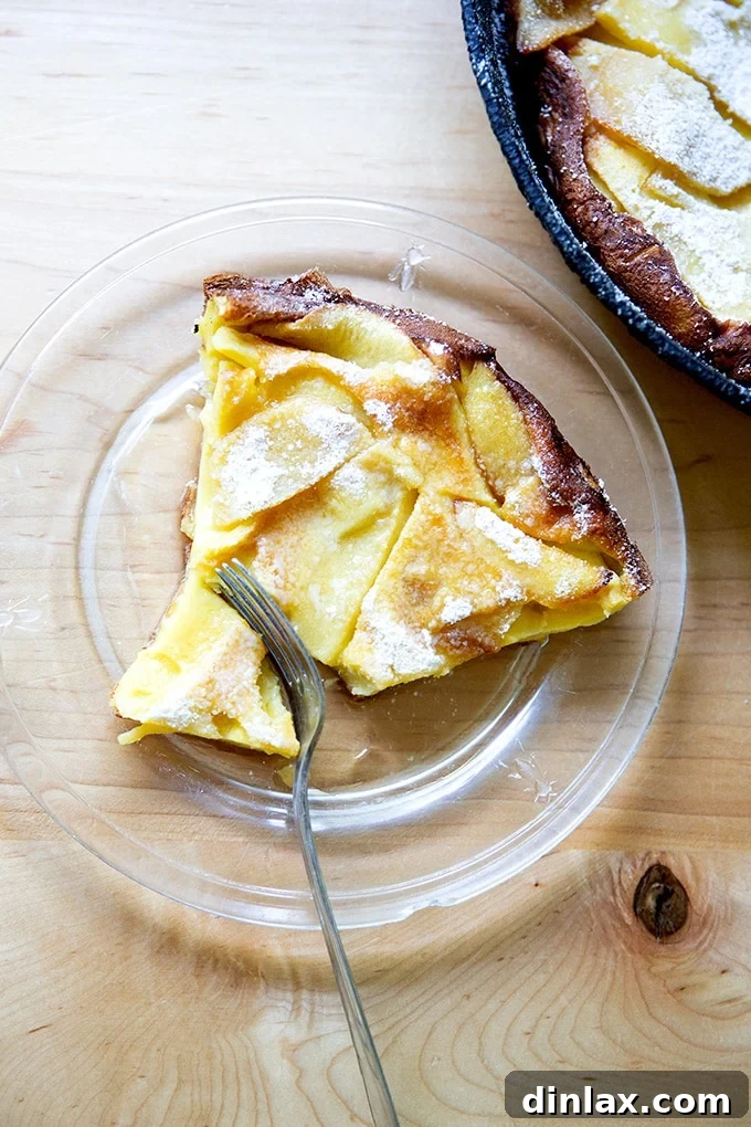 Golden Apple Skillet Pancake 2 A close-up slice of an Apple Dutch Baby, showing the custardy interior.