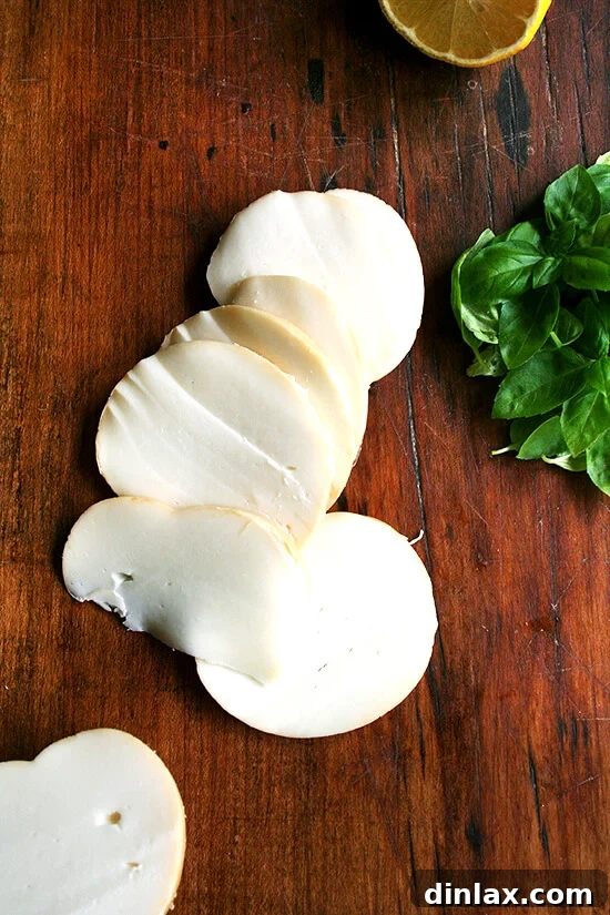 Zesty Lemon, Smoked Mozzarella & Fresh Basil Pizza 4 Sliced smoked mozzarella on a board.