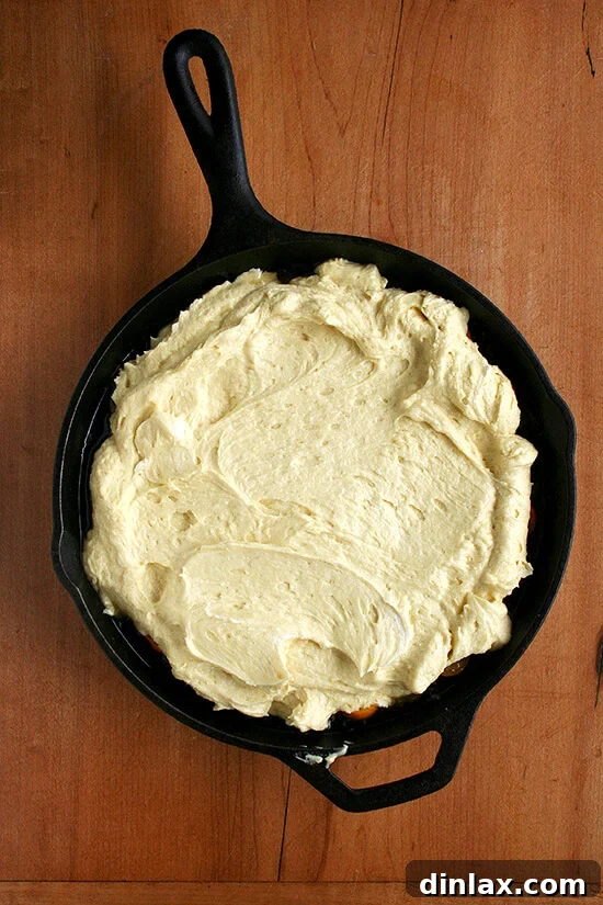 Golden Kumquat Crown Cake 5 Smooth, golden cake batter carefully spooned over the caramelized kumquats in the skillet.