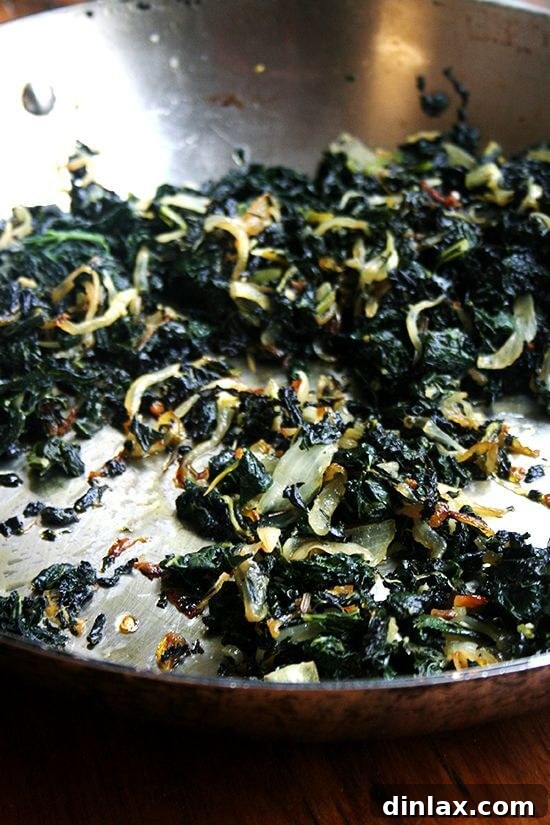 Transformative Slow-Cooked Kale by Suzanne Goin A close-up of deeply caramelized slow-cooked kale, a transformative vegetarian dish.