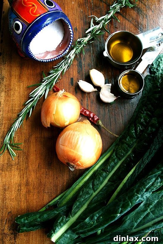 Stuffing-Style Slow-Cooked Kale by Suzanne Goin 2 Ingredients for slow-cooked kale including Tuscan kale, olive oil, onion, garlic, rosemary, and chile de árbol.