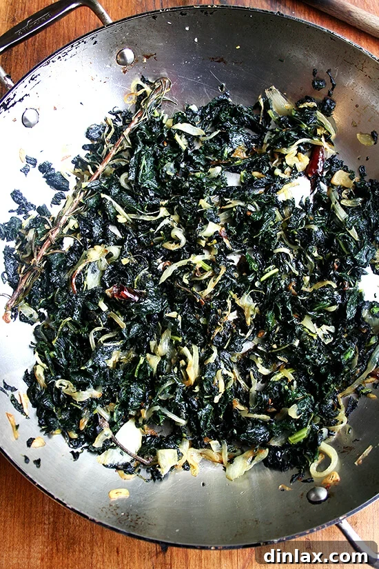 Rich and Savory Slow-Cooked Tuscan Kale A finished plate of savory slow-cooked Tuscan kale, dark and rich in color.