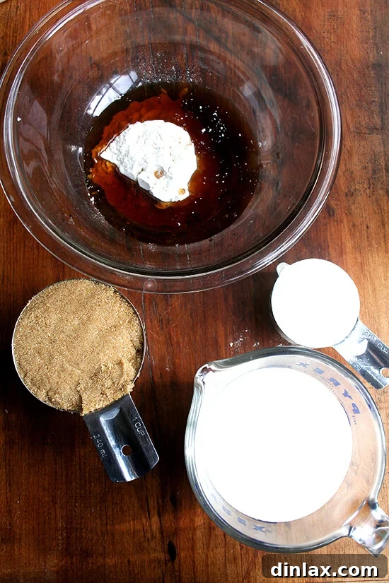 A glimpse at the simple yet essential ingredients that come together to create the irresistible maple cream tart. Various ingredients for maple cream tart laid out on a kitchen surface.