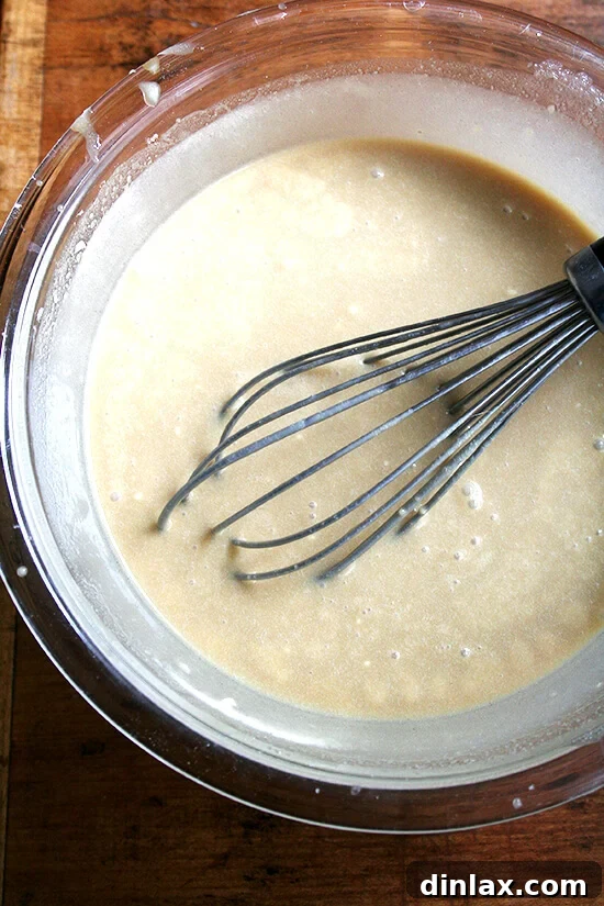 The velvety smooth maple cream custard, a key component, ready to be poured into the tart shell. Maple cream tart custard mixture in a bowl, showing its smooth consistency.