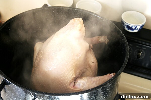 A large turkey steaming in preparation for roasting, promising a succulent holiday meal.