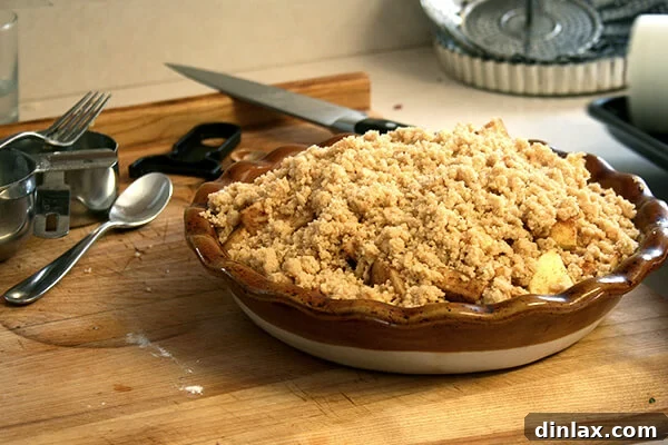 Darcy's homemade apple crumble, with a golden topping, awaiting baking – a truly delicious dessert.
