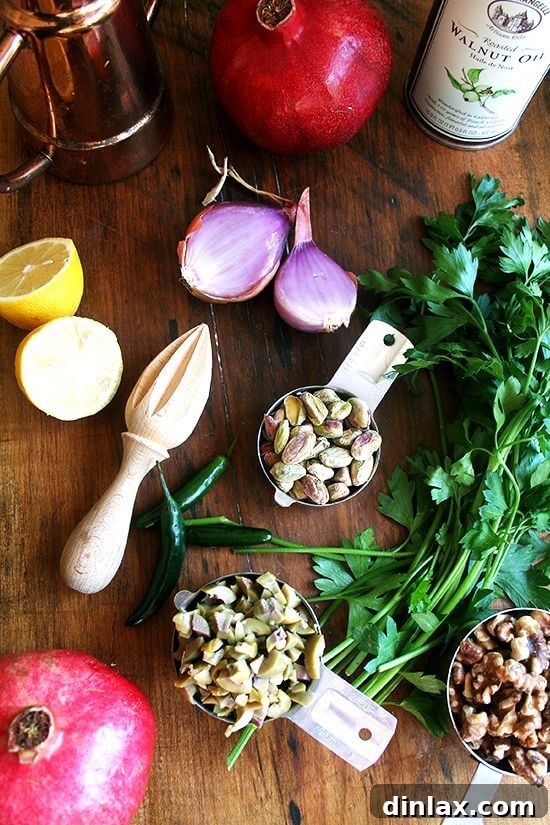Fresh ingredients for a vibrant green olive, walnut, and pomegranate salad.
