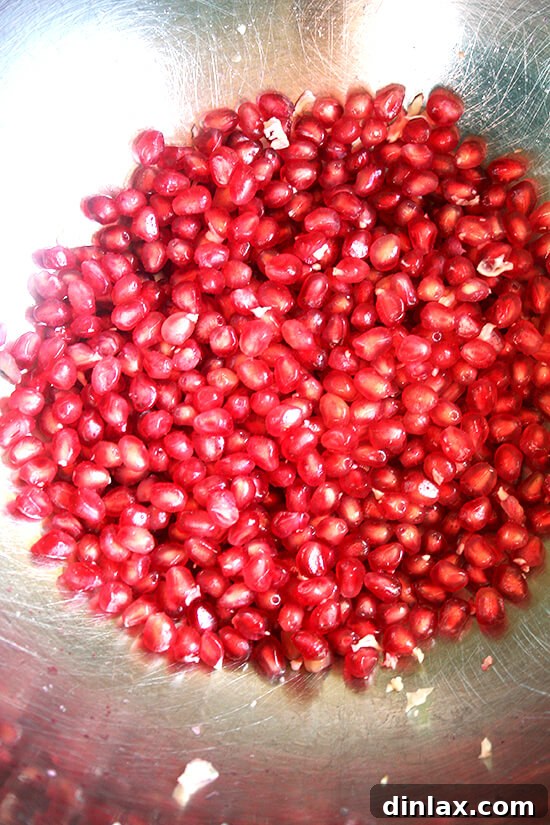 Bright red pomegranate seeds, adding a pop of color and tartness.