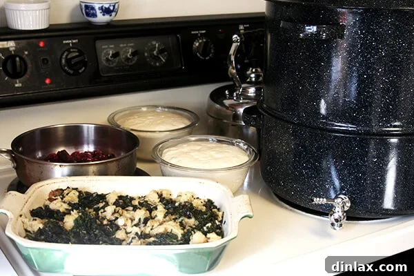 Thanksgiving preparations in full swing: simmering cranberry sauce, rising bread, and stuffing ready for the oven.