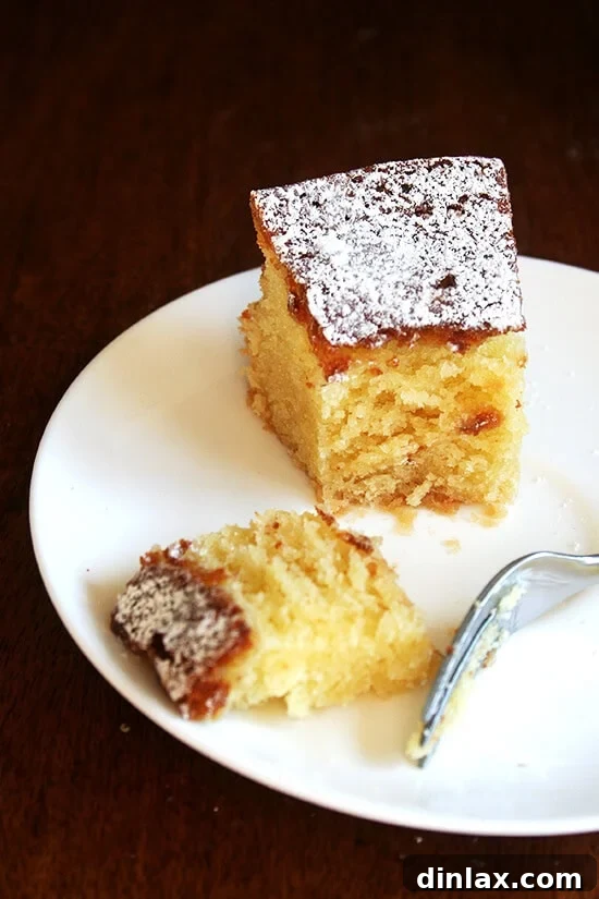 Truly, this almond torte, made entirely in the food processor, is one of the simplest and most delicious desserts you could ever prepare. It's definitely for almond/marzipan lovers and tastes better with each passing day, so don't be afraid to make it a day or two in advance if you're preparing for a holiday gathering. // alexandracooks.com A beautifully sliced Chez Panisse almond torte, lightly dusted with powdered sugar, resting on a white plate, ready to be enjoyed.