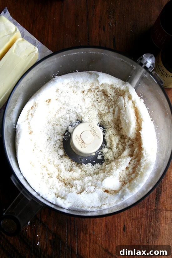 Classic Chez Panisse Almond Torte 6 Sugar and soft almond paste being blended together in a food processor, transforming into a fine, uniform mixture.