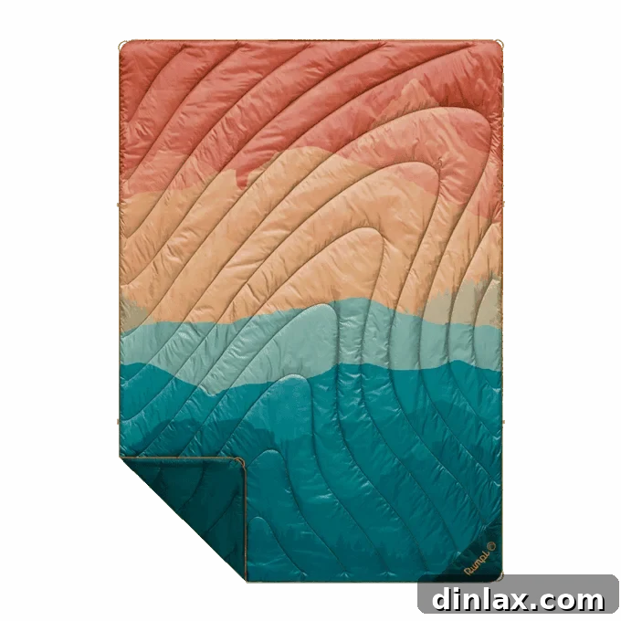 9 Awesome Father's Day Gift Ideas 17 A vibrant and inviting Rumpl puffy blanket, showcased outdoors, ideal for camping, travel, or simply adding a touch of comfort.