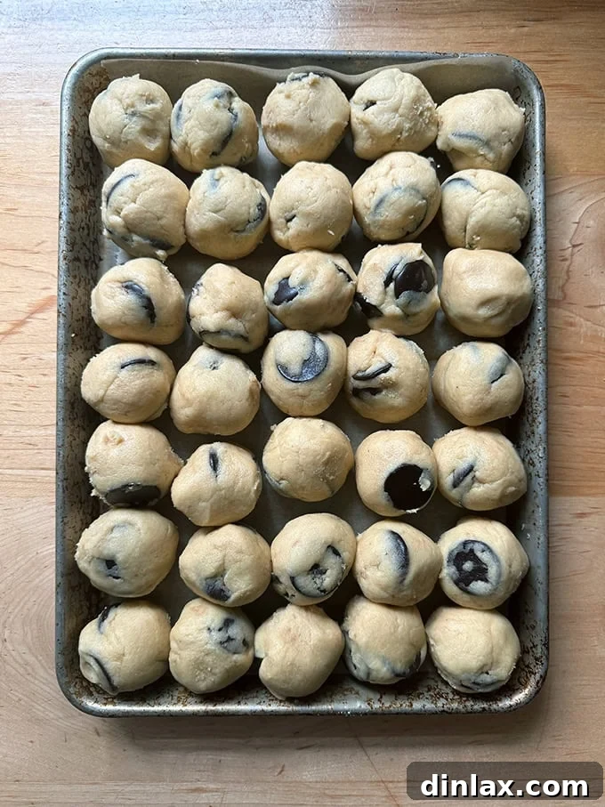 9 Awesome Father's Day Gift Ideas 7 A baking sheet filled with perfectly scooped, unbaked chocolate chip cookie dough balls, arranged for freezing or baking.