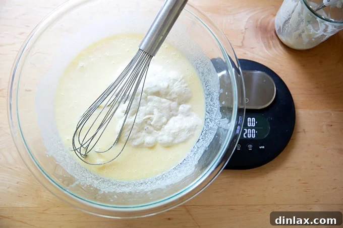 Quick Light and Fluffy Sourdough Discard Pancakes 6 A large bowl on a scale filled with the wet ingredients to make sourdough discard pancakes.