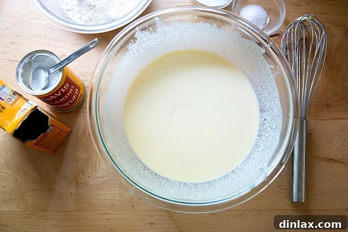 Quick Light and Fluffy Sourdough Discard Pancakes 7 A large bowl filled with the wet ingredients to make sourdough discard pancakes all whisked together.