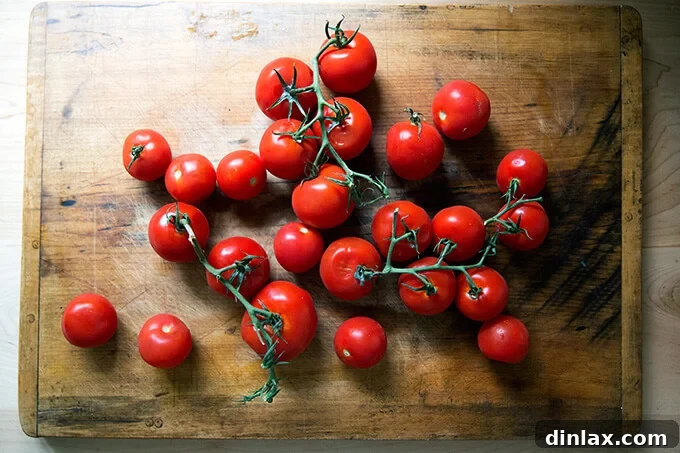 Oven-Dried Tomatoes and Delectable Toasts 4 Fresh vine-ripened tomatoes on a wooden cutting board