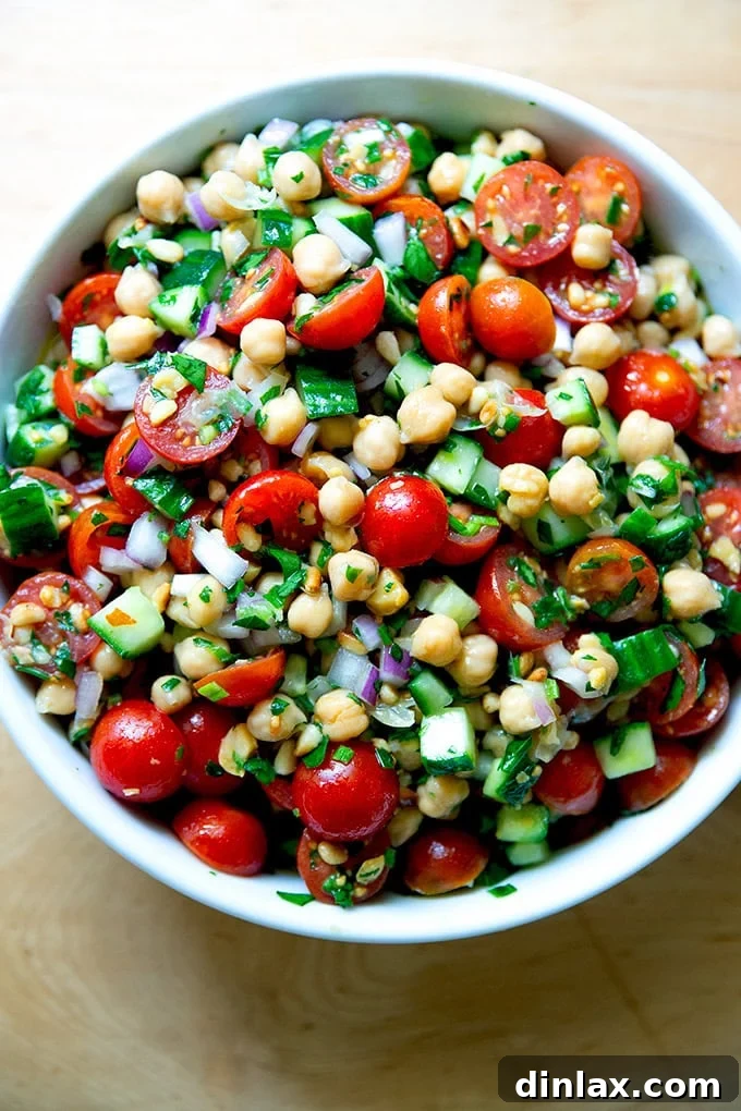 The finished lemony herby chickpea salad, elegantly presented in a large serving bowl, ready to be enjoyed.