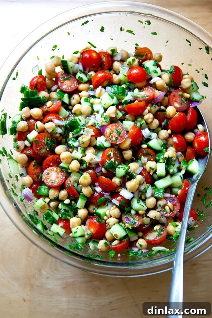 A close-up shot of the fully assembled and perfectly tossed lemony herby chickpea salad, showcasing its rich textures and vibrant colors.