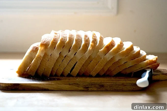 Neatly sliced sourdough discard toasting bread, arranged on a cutting board, highlighting its appealing texture.