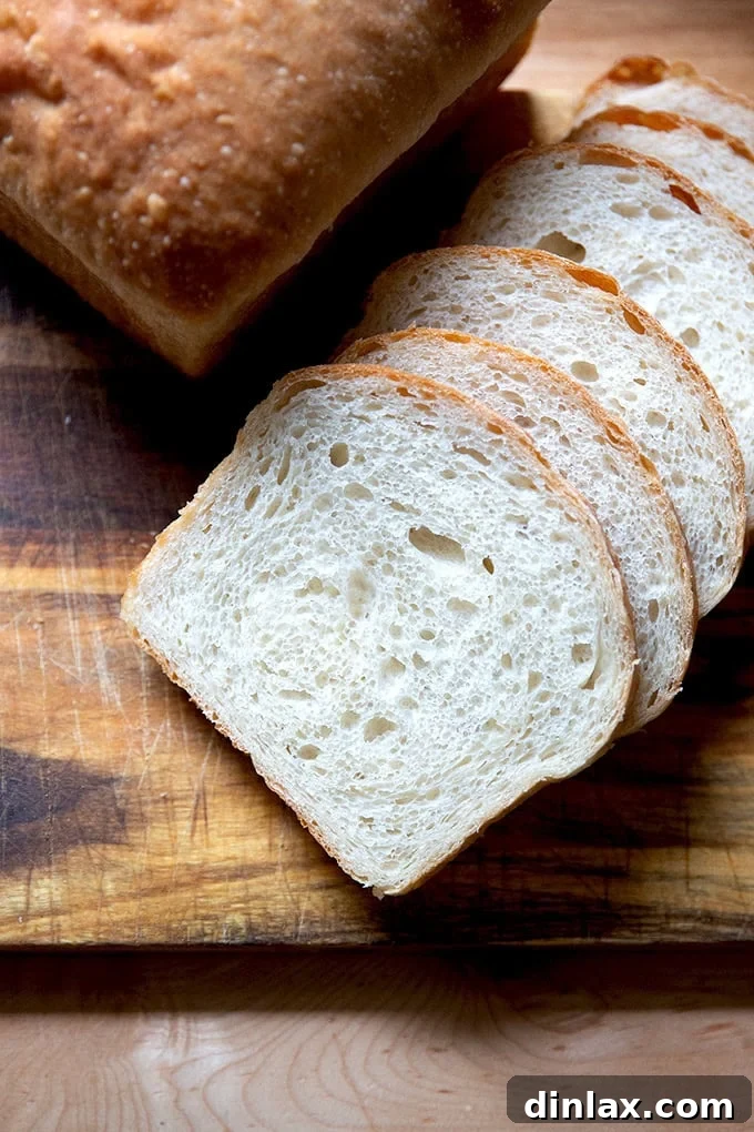More artfully arranged slices of sourdough discard toasting bread on a cutting board, emphasizing its versatility and appeal.