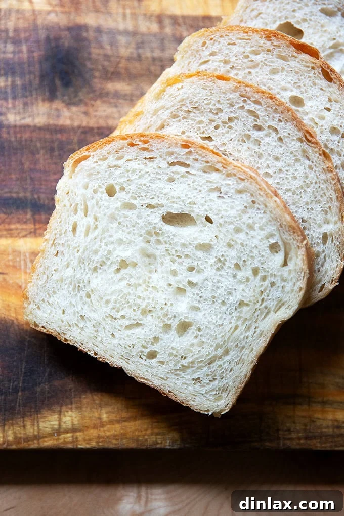 Another view of the beautifully sliced sourdough discard toasting bread on a cutting board, ready to be enjoyed as fresh sandwiches.