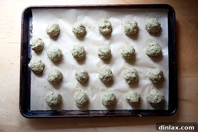 Smoky Eggplant Vegan Meatballs 12 Shaped eggplant meatballs unbaked on a sheet pan.