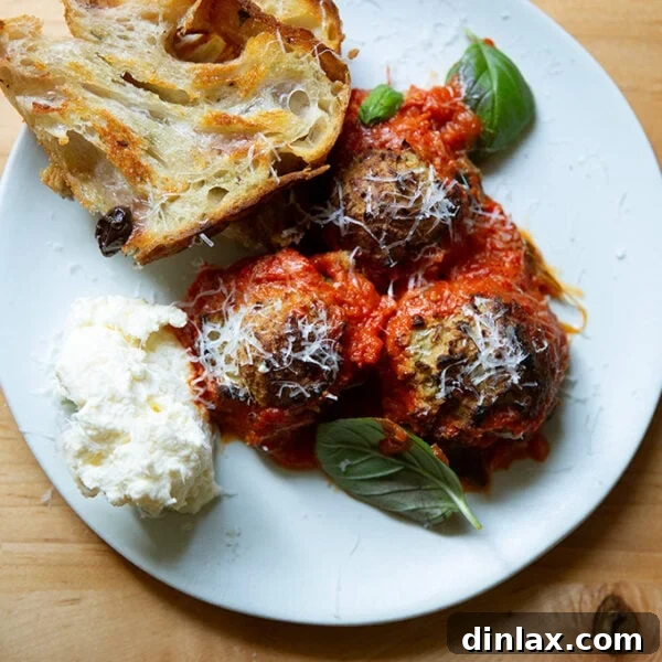 A plate of eggplant meatballs aside bread and ricottta.