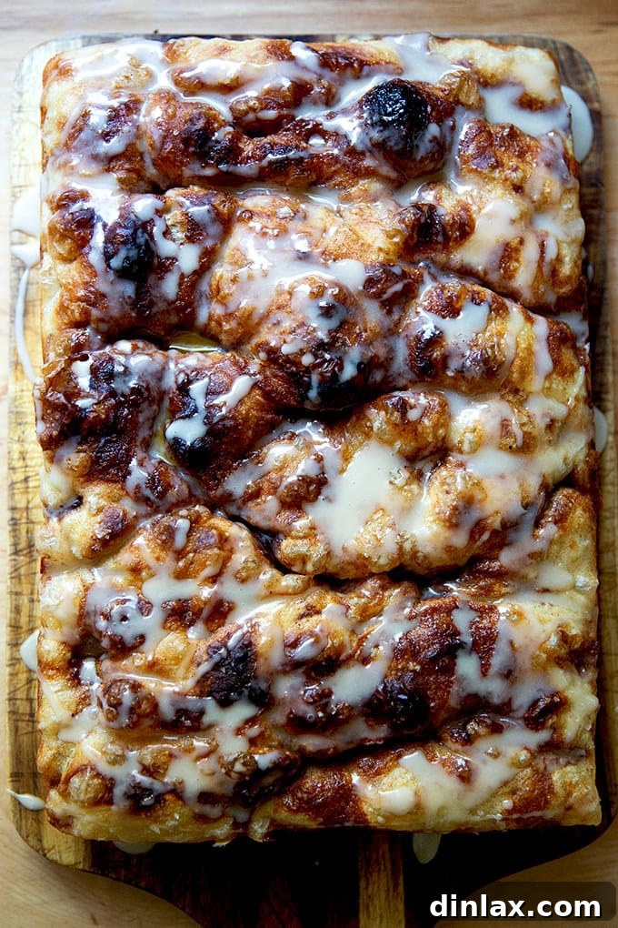 Effortless Cinnamon Sugar Focaccia 2 Beautifully baked cinnamon-sugar focaccia on a rustic serving board, showcasing its golden crust and delicious glaze.