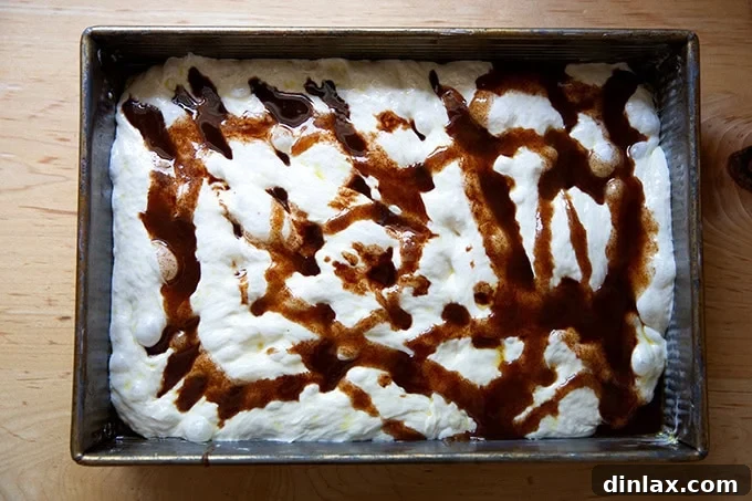 Effortless Cinnamon Sugar Focaccia 16 Focaccia dough in the pan, completely covered with the first layer of cinnamon-sugar-butter mixture, ready for folding.