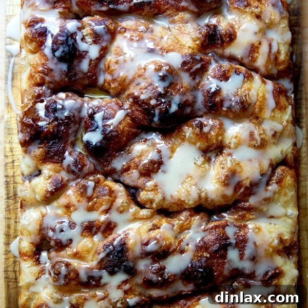 Cinnamon-sugar focaccia on a serving board, beautifully glazed and ready to eat.