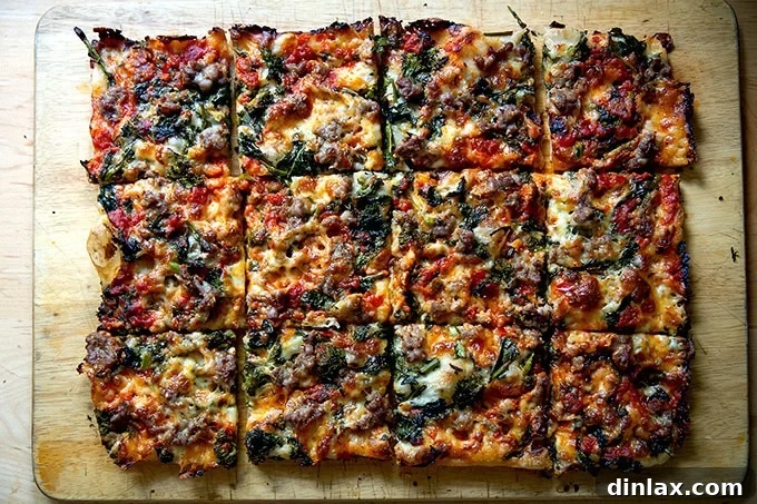 A freshly baked Grandma-style pizza, expertly cut into numerous square slices, resting on a rustic wooden cutting board, ready to be served.