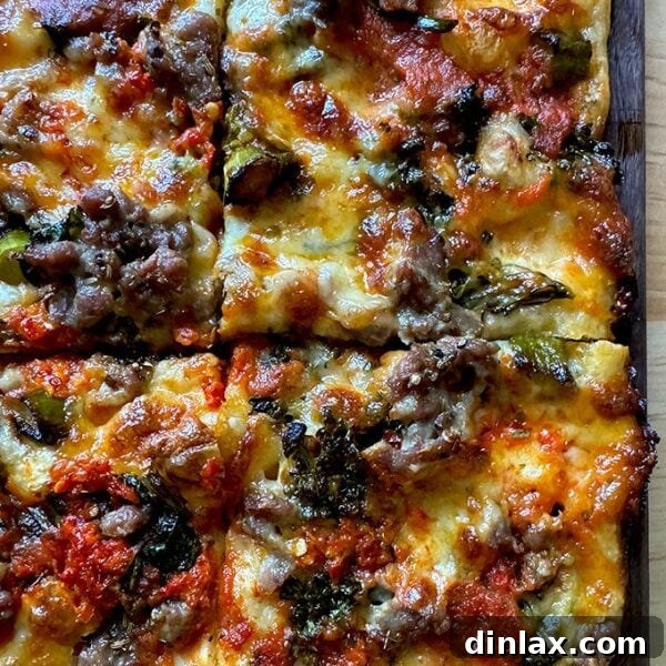 Grandma-style pizza on a cutting board cut into square slices.