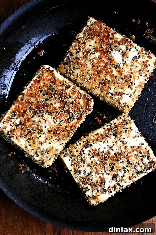 Golden Sesame Tofu with Tangy Nuoc Cham Drizzle 12 Tofu slices being crisped to a golden perfection in a hot non-stick skillet.