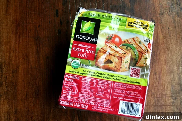 Golden Sesame Tofu with Tangy Nuoc Cham Drizzle 3 A block of extra-firm tofu, perfectly prepared for slicing and cooking.