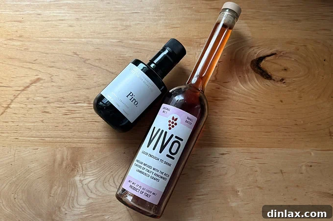A sophisticated pairing of a bottle of Vivo red wine vinegar and Piro extra-virgin olive oil, highlighting their gourmet appeal.