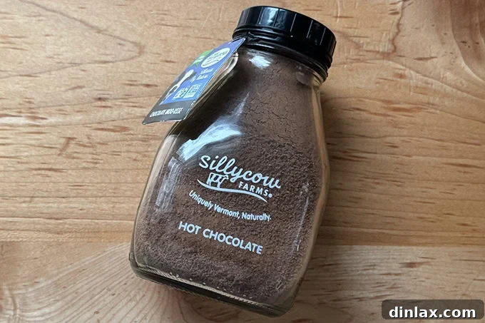 A charming tin of Sillycow hot chocolate mix, suggesting a comforting and delicious beverage for cozy moments.